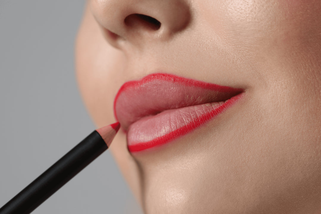 Woman applying a cruelty-free, organic lip pencil by Baily Cosmetics to achieve a gorgeous and long-lasting color while supporting eco-conscious beauty.